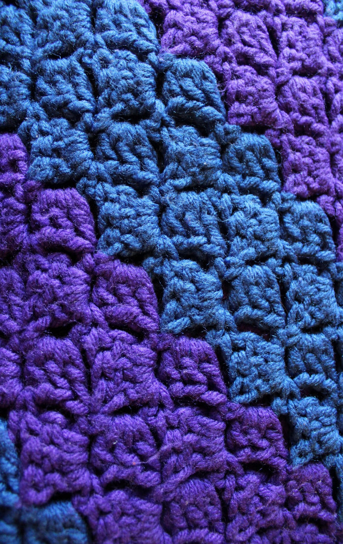 Crocheted blanket in shades of blue and purple